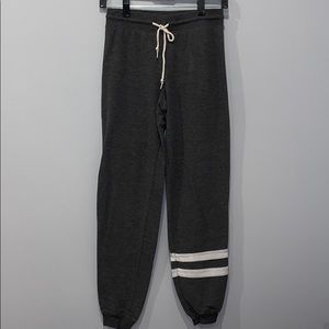 grey joggers with strips on the leg